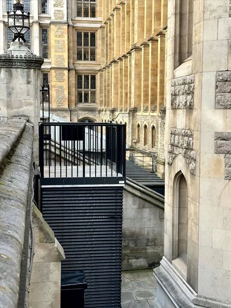 Lightwell lift adjacent to a building